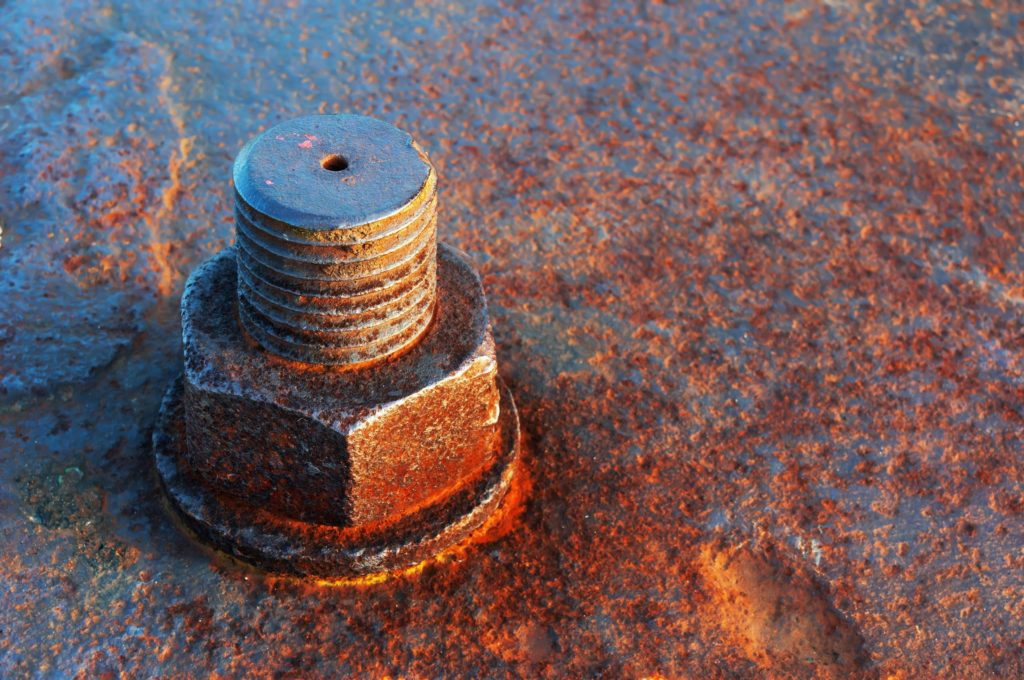 Metal bolt with advanced corrosion due to exposure to harsh environmental conditions
