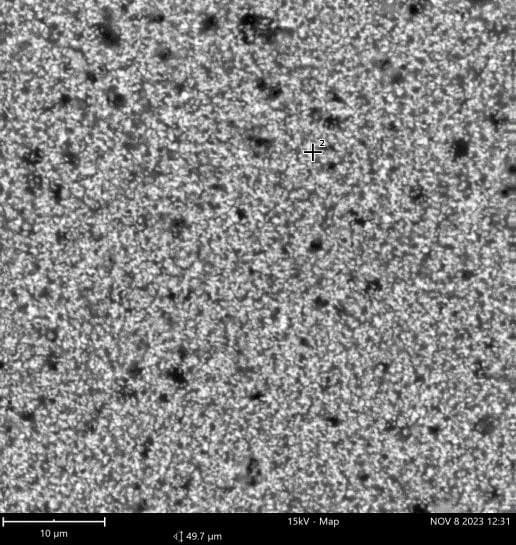 Electron microscopy image showing surface defects in electronic components at micrometer scale
