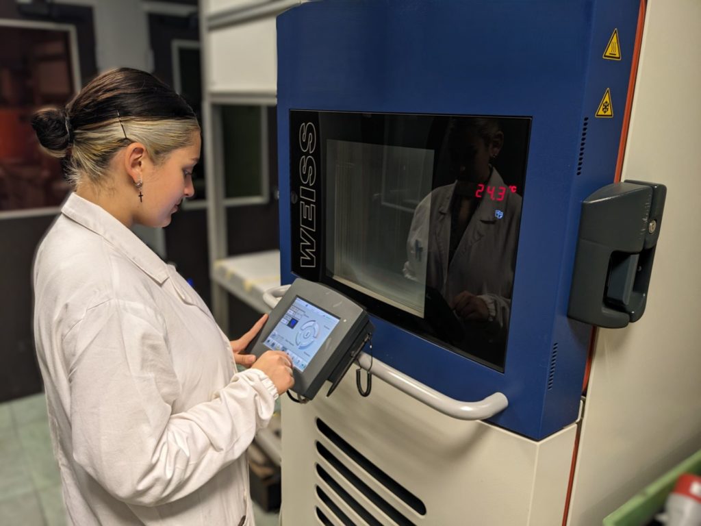 Technician performing ageing test in environmental chamber for composite material validation
