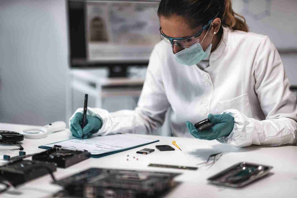 Technician analyzing electronic component failures through detailed inspection