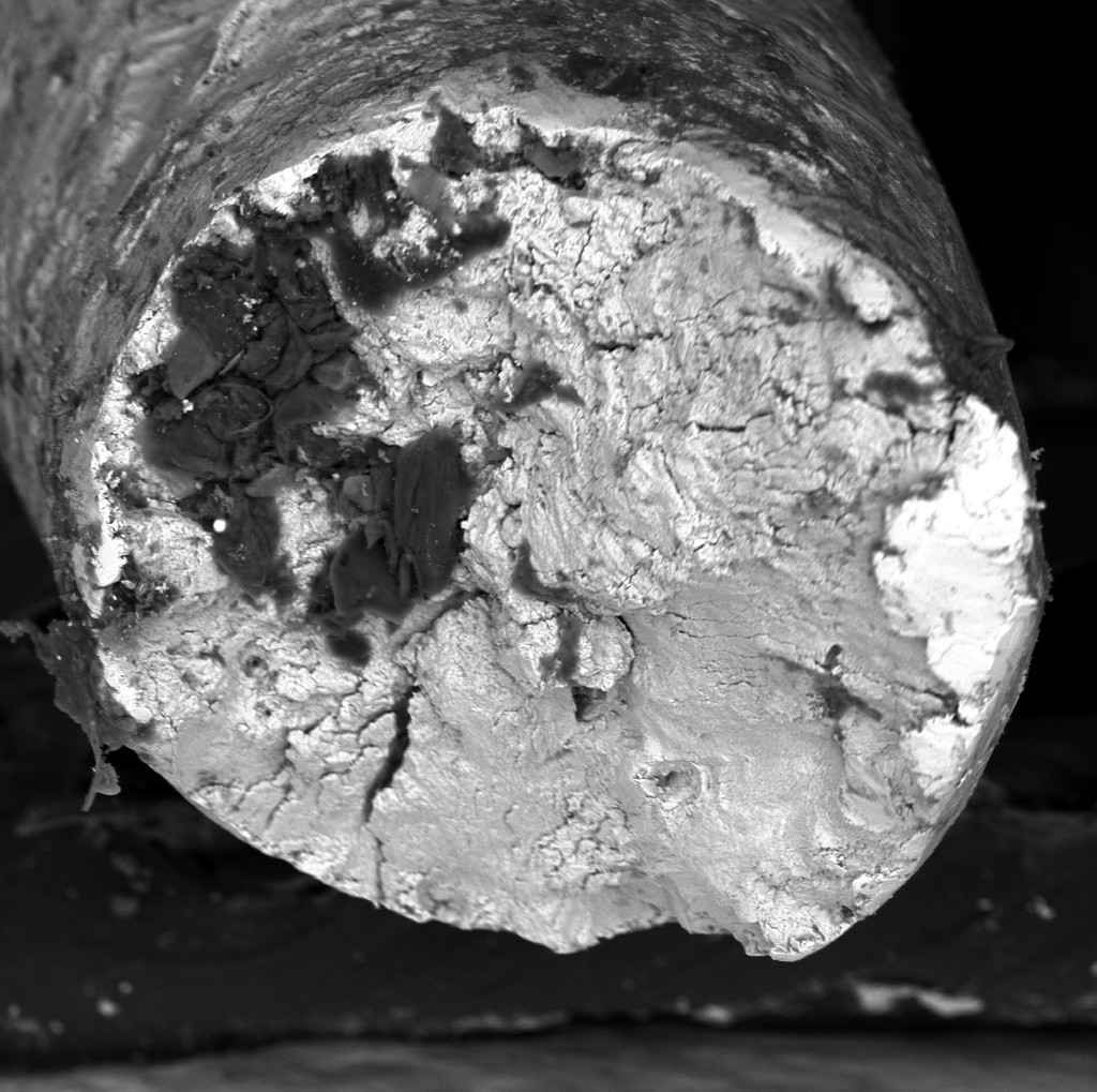 Section of metal component showing fatigue fracture and crack propagation zones