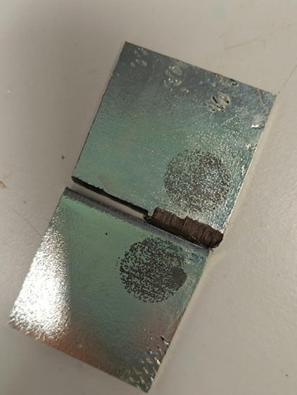 Steel specimens with metallic coatings after corrosion testing to evaluate the resistance of steel coatings in saline environments.