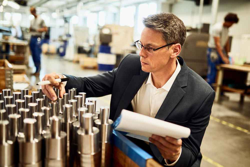Engineer inspecting metal components during the material selection process for an industrial application
