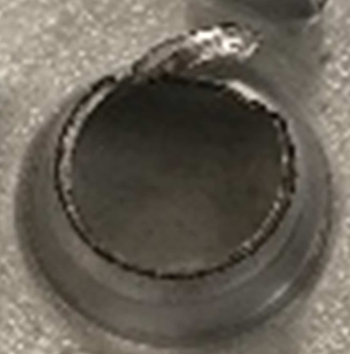 Detail of breakage in a metal part during industrial assembly used in component failure analysis