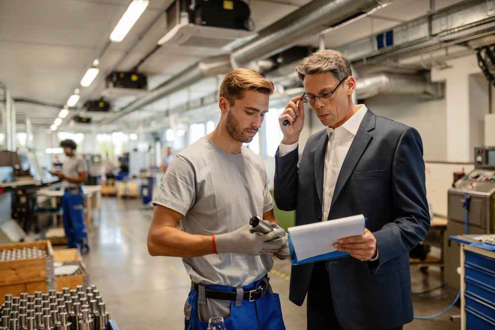 Engineer inspecting a component in a factory to analyze whether the failure is due to the material, design, or process