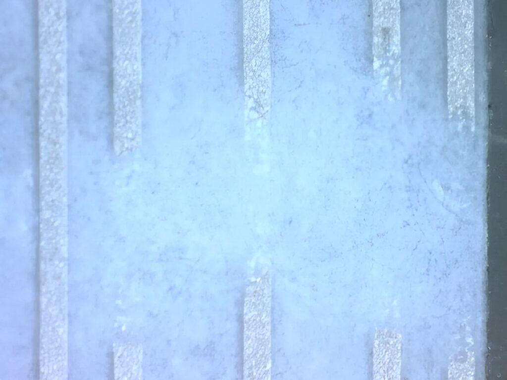 Microscopic detail of conductive tracks in a flexible circuit during electronic failure diagnosis