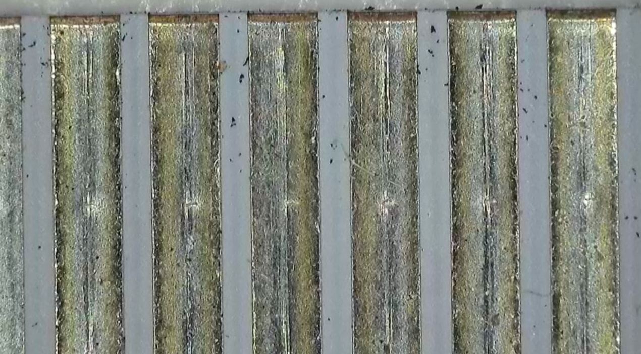 Microscopic image of unknown residues detected in an electrical component during a failure analysis investigation.