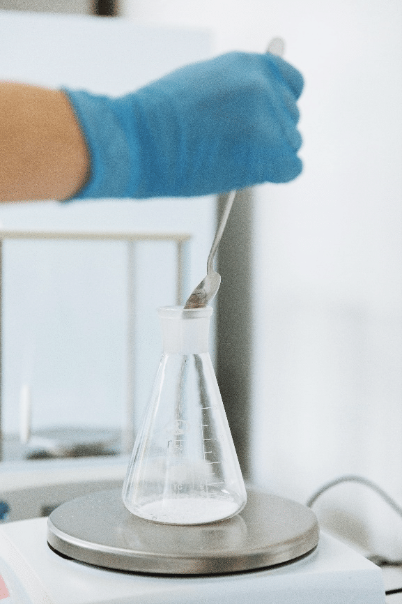 Technician performing chemical characterization of industrial waste in laboratory to define a decontamination strategy