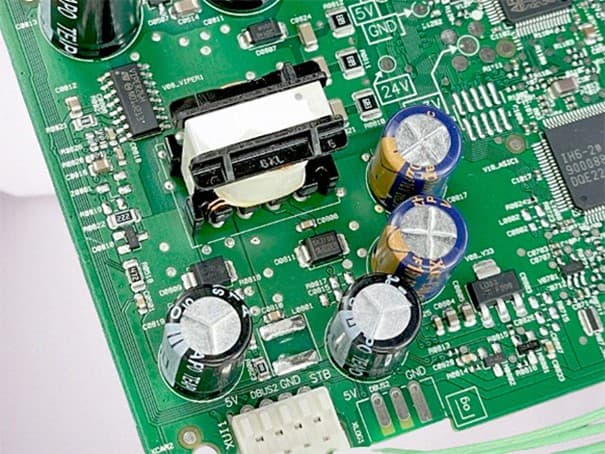 Electronic PCB with capacitors analyzed through reverse engineering to detect counterfeit components