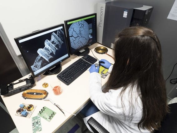 Engineer analyzing material microstructure to determine the cause of an industrial failure