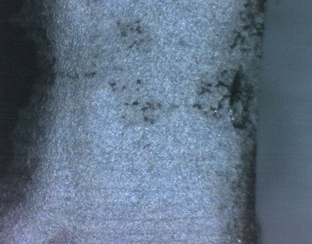 Surface detail showing defects in aluminium anodising observed through microscopic analysis during the root cause study