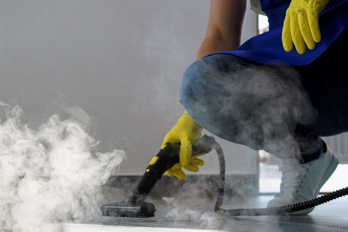 Steam disinfection applied with a steam cleaner to remove microorganisms from surfaces