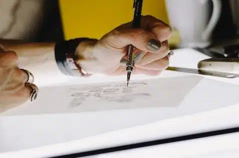Redesign of the graphic image to reflect corporate identity Hand sketching with a marker during a graphic identity redesign