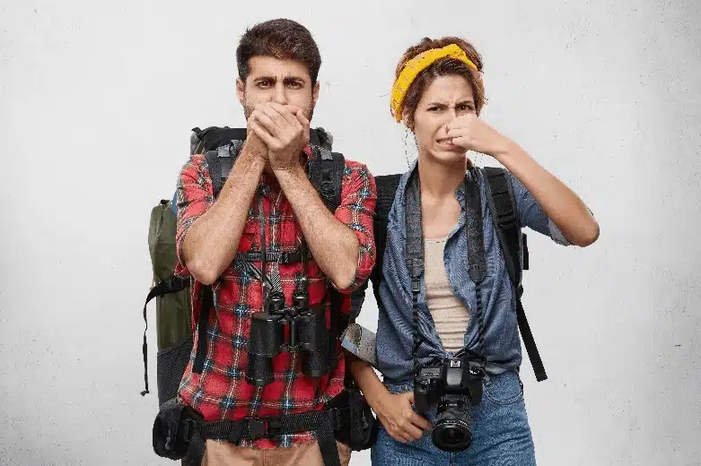 Analysis of odors and gases in a vehicle interior Two people holding their noses at a bad smell