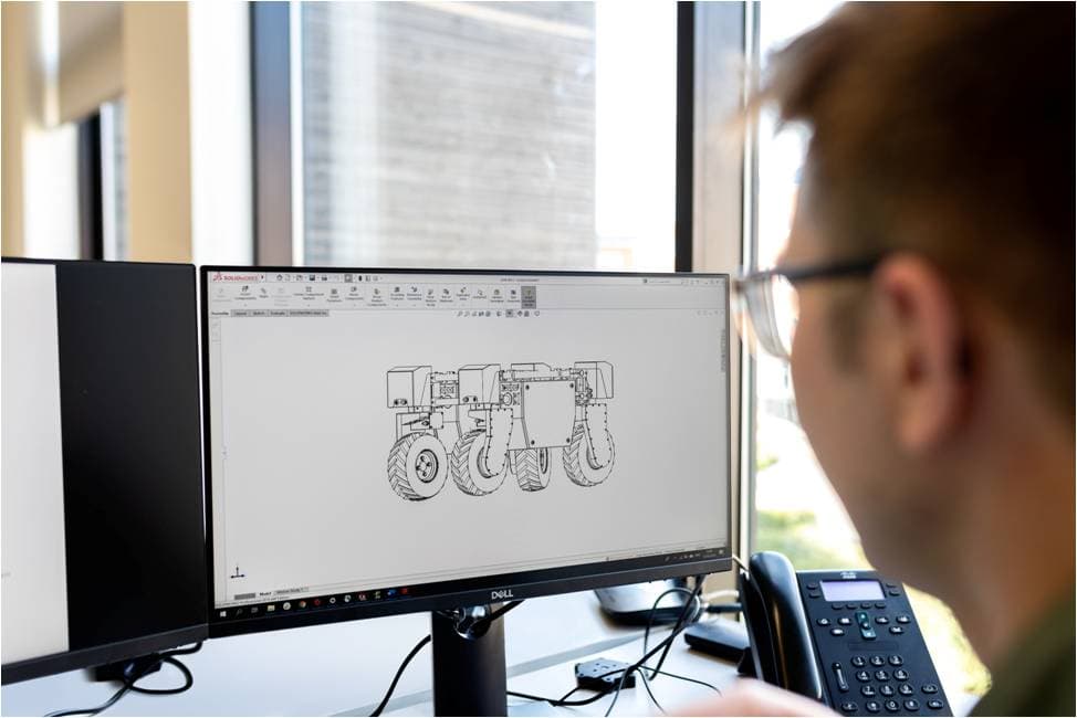 Component design by reverse engineering and 3D scanning Engineer reviewing on screen the CAD drawing of a reverse engineered component