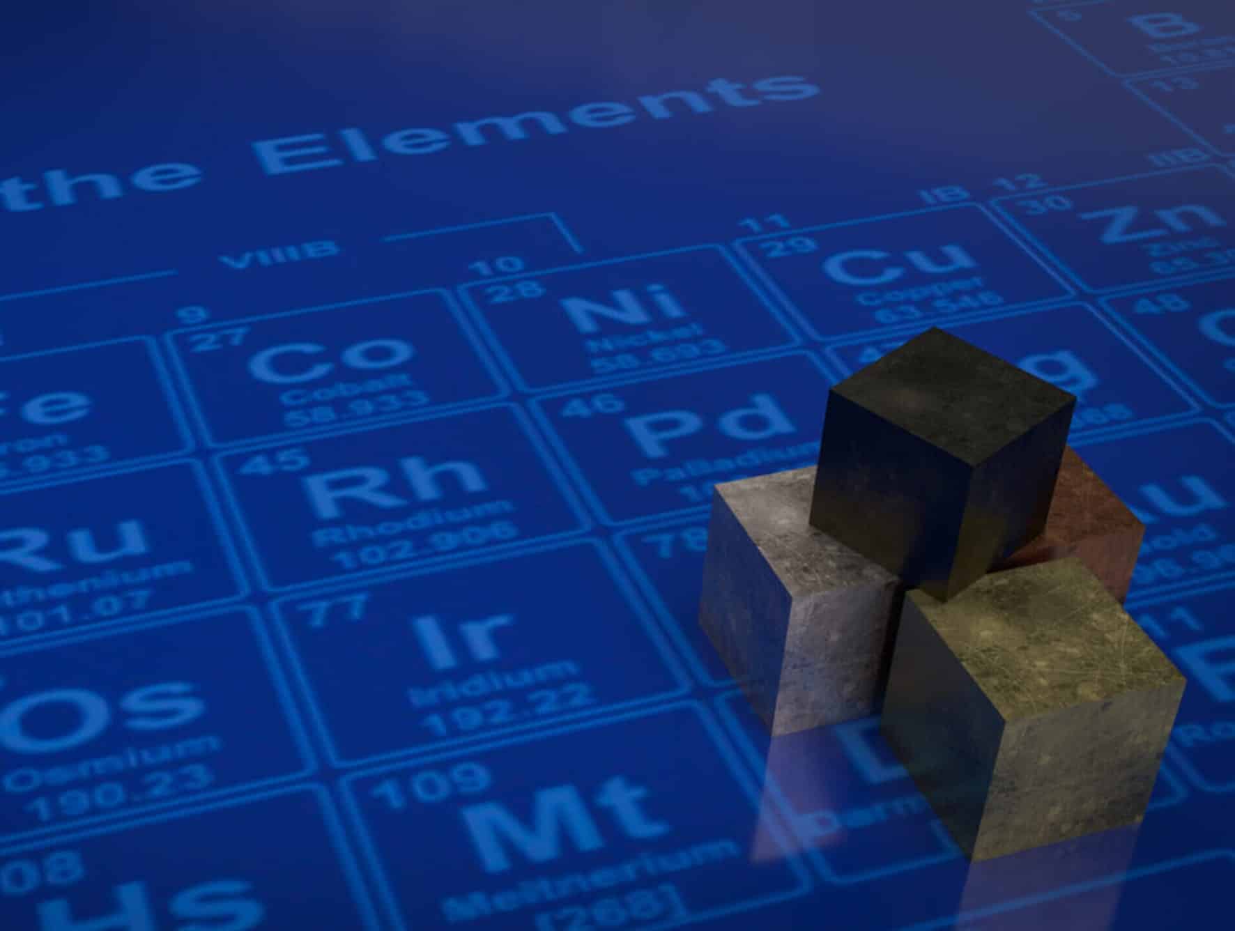 Person in front of an illuminated periodic table representing elemental analysis of metals